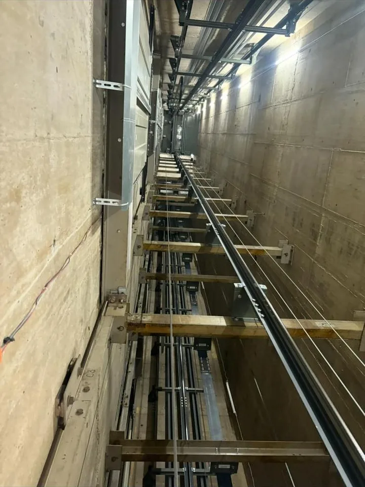 Passenger lift shaft with guide rails and counterweight during a LOLER examination in Edinburgh
